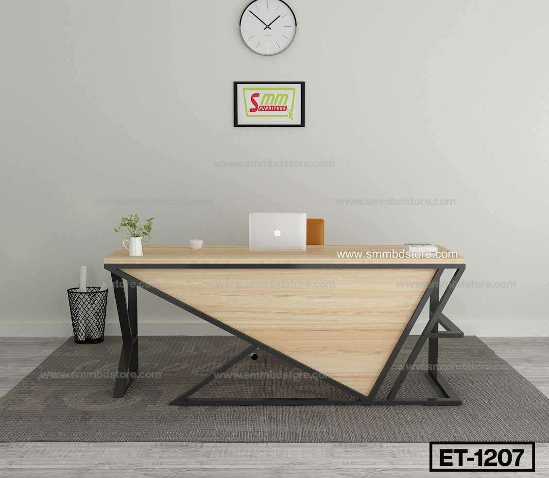 Modern wooden office desk with black metal frame, laptop, plant, and minimalist decor