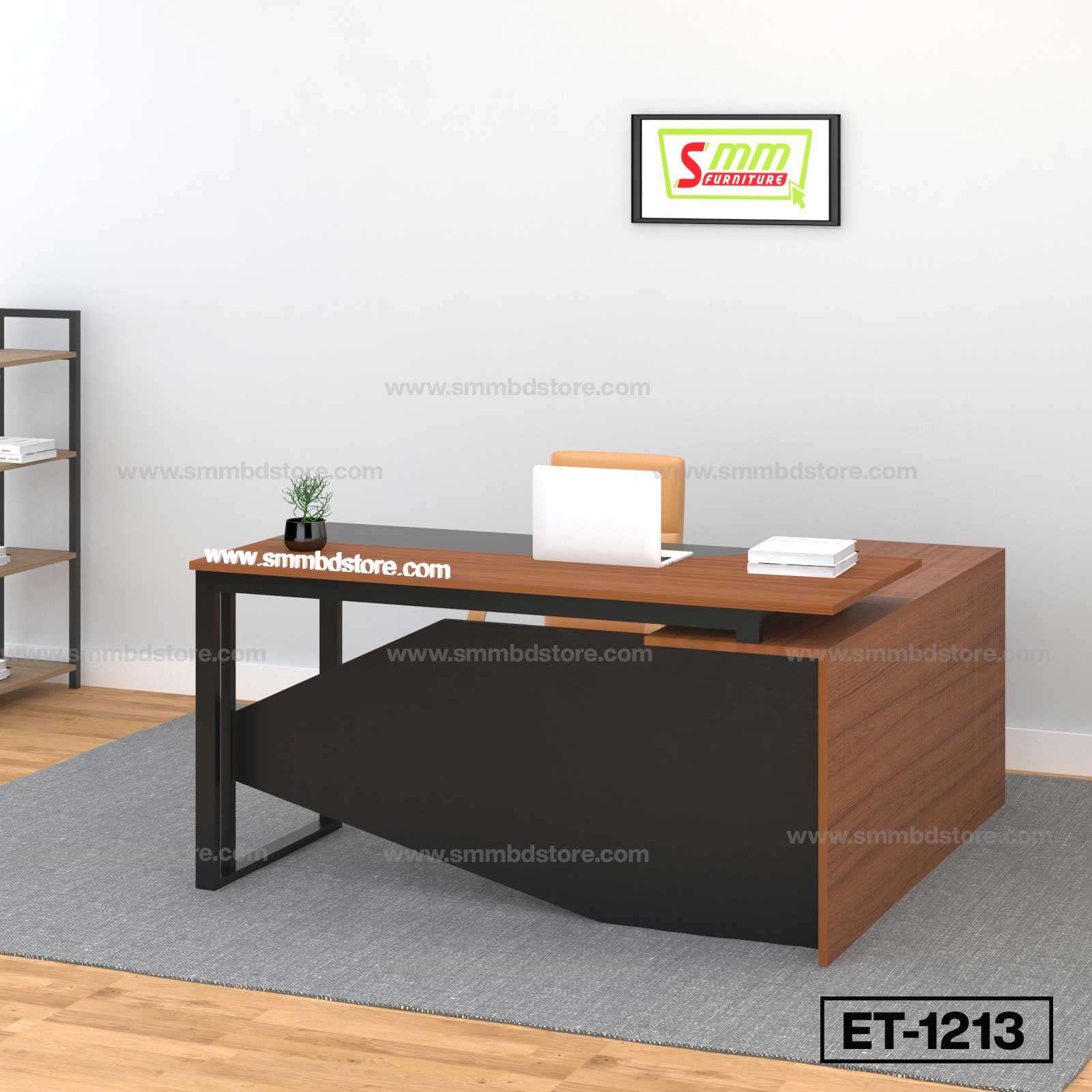 Modern office desk with wood and black finish, laptop, plant, books, and wall art in workspace