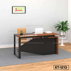 Modern office desk with black frame, brown tabletop, chair, laptop, indoor plant, and office decor