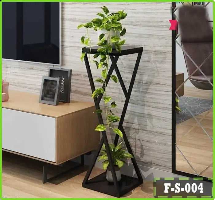 Modern geometric indoor plant stand with green leafy plant, placed beside a TV stand and mirror