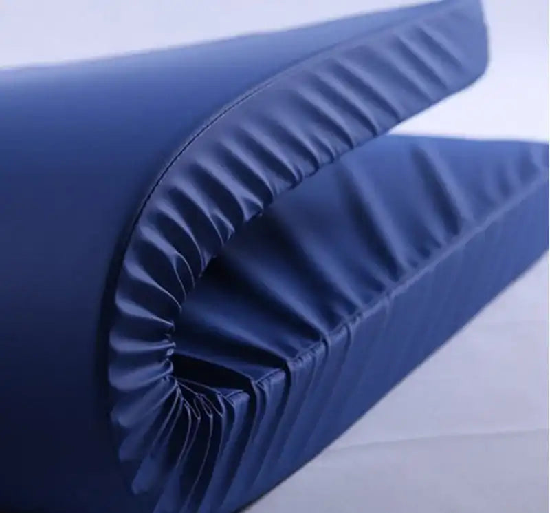 Folded blue hospital bed mattress with smooth, waterproof cover on a white background.