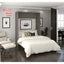 Modern wall bed in a stylish bedroom with minimalist decor, neutral colors, and art prints